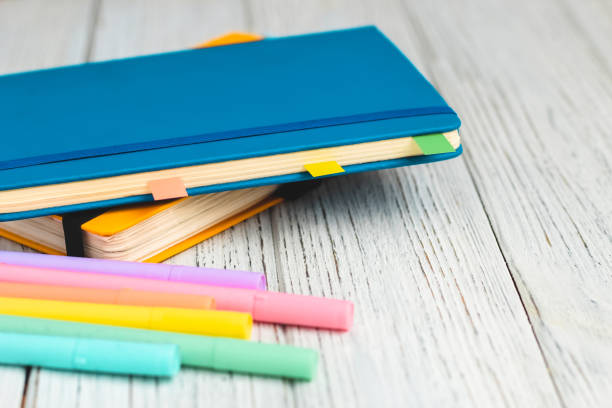 istock Notebook diary for planning in blue and yellow and colored cardboard for creativity 1570008552
