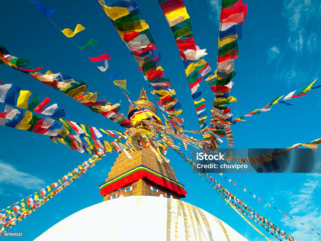 Buddhist prayer flags against blue sky, Boudhanath Stupa, Kathmandu, Nepal Boudhanath Stupa, in Kathmandu, Nepal. Colorful traditional Buddhist prayer flags against blue sky. Kathmandu Stock Photo