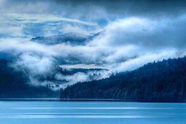 Blue lake landscape with foggy clouds at evening dusk at Lake Crescent, National Olympic Park Washington