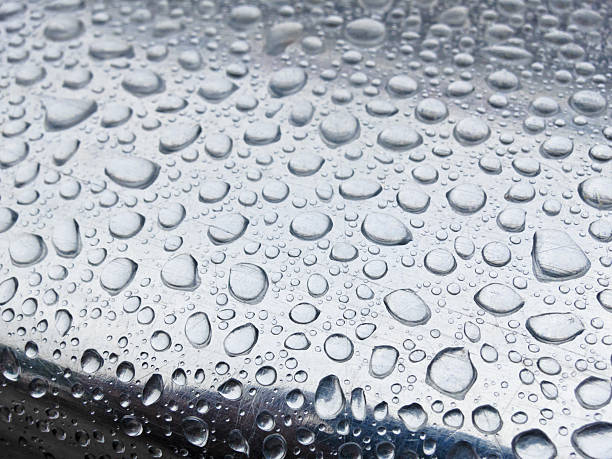 Rain drops on a metal surface stock photo