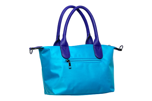 Stylish women's handbag. A fashionable female blue luxury handbag isolated on white. Fashionable womans accessories. Advertising.