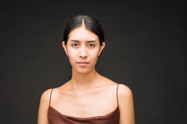istock Attractive elegance portrait. Beautiful Latin friendly people in studio with black background 1570020468