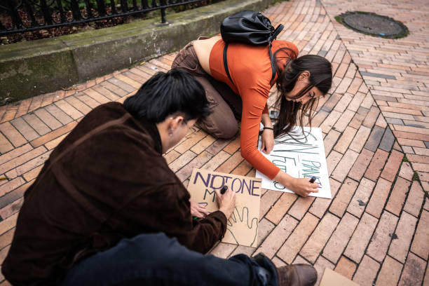 istock Young protesters friends preparing posters before the protest outdoors 1570021534