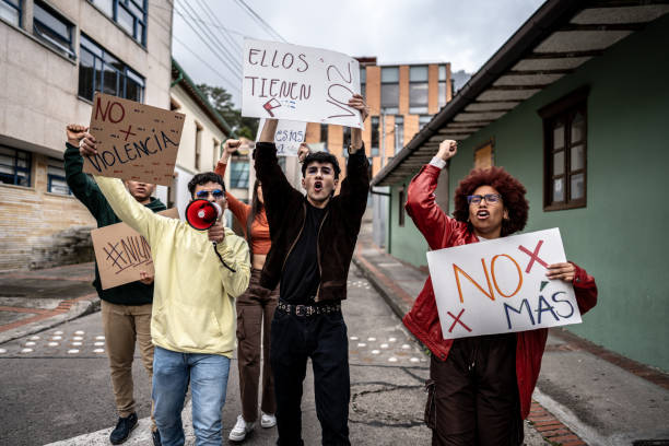 istock Young protesters holding banners on a demonstration against violence outdoors 1570023169