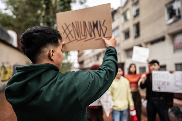 istock Young protester man holding a banner on protest outdoors 1570023721