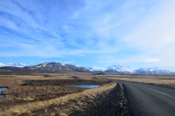 istock Road Trip with Snow Covered Mountains and Stunning Scenery 1570025403