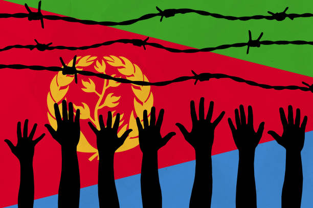 istock Eritrea flag behind barbed wire fence. Group of people hands. Freedom and propaganda concept 1570039156