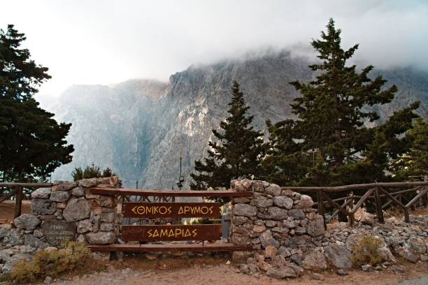 istock Majestic stone gate stands tall atop a mountain, with billowing clouds in the background 1570040837