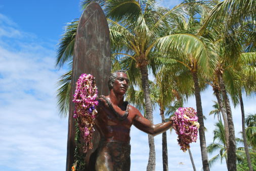 Statue of a surfer welcomes you to Waikiki with open arms.