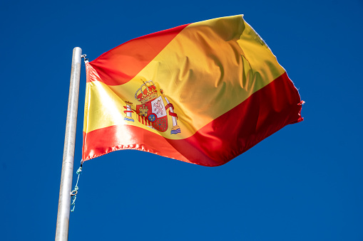 a Spain flag fluttering in the wind
