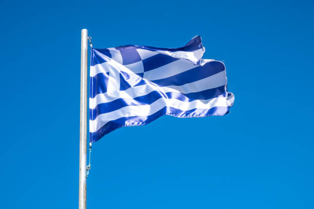 istock a Greece flag fluttering in the wind 1570061645