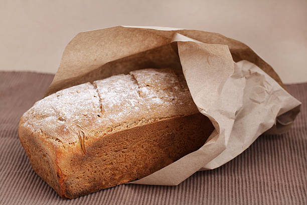 istock Loaf bread from corn flour wrapped in brown paper 157006601
