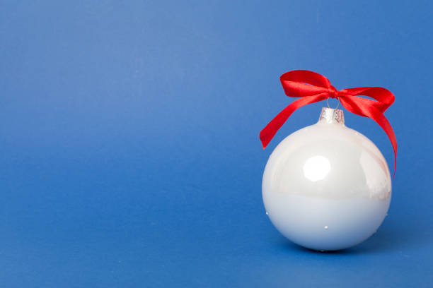 Christmas white baubles on the wooden background