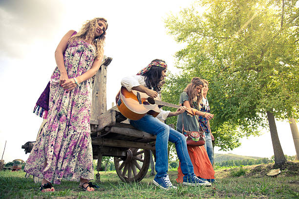 istock Hippie group playing guitar and dancing together 157009628
