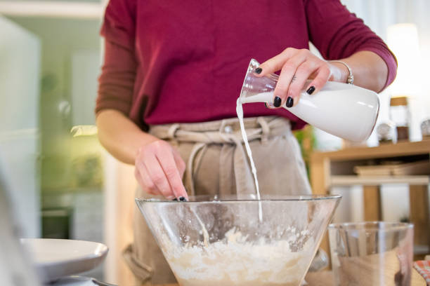 istock A young beautiful woman is preparing pancakes 1570097027