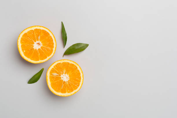 istock Flat lay with fresh oranges and leaves on color background 1570101848
