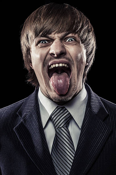 istock young businessman shouting with his tongue stuck out 157010866