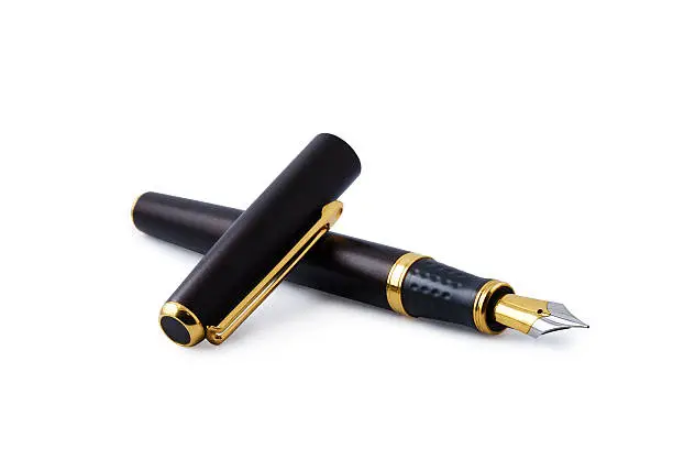 Elegant gold plated business fountain pen isolated on white with cap. Clipping path included. Copy space.