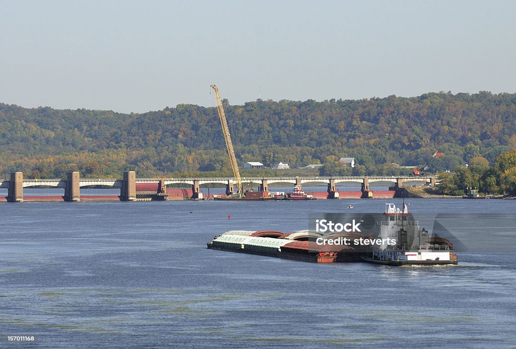 Barge on River Barge on Mississippi River approaching dam that is under construction. Autumn Stock Photo