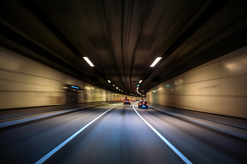 Cars riding in the urban tunnel, blurred in motion