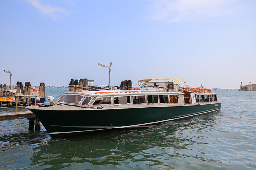 Venice, Italy - 21 July, 2019:  Passenger excursion boat moored at the pier in Venice