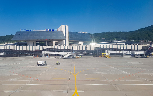 London, UK - June 05, 2008: Planes parked at the gates at Heathrow Airport. Maintenance staff are pictured