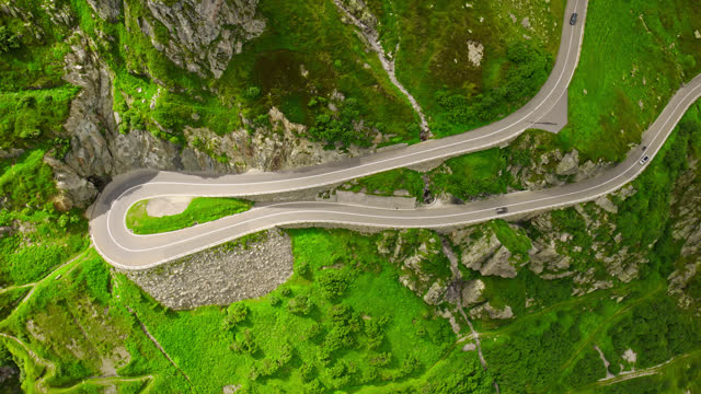 Hairpin Bend in Road through Swiss Alps - Top Down Drone Shot