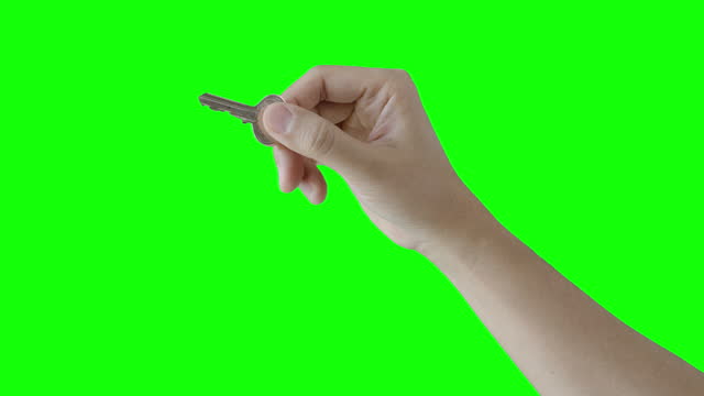 Hand of Woman Holding Key on Green Screen
