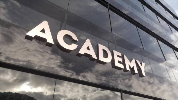 istock Academy sign on a modern glass skyscraper. Public education, learning, high school and university concept. 3d illustration 1570170806