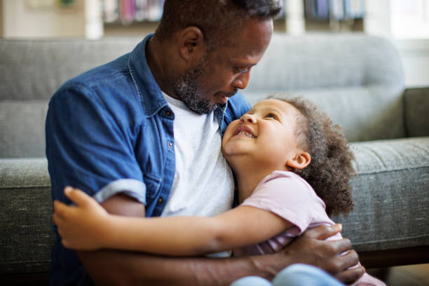 istock Father and daughter embracing at home 1570174625