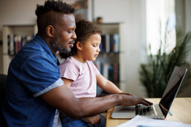 istock Father working at home, carrying young daughter 1570186854