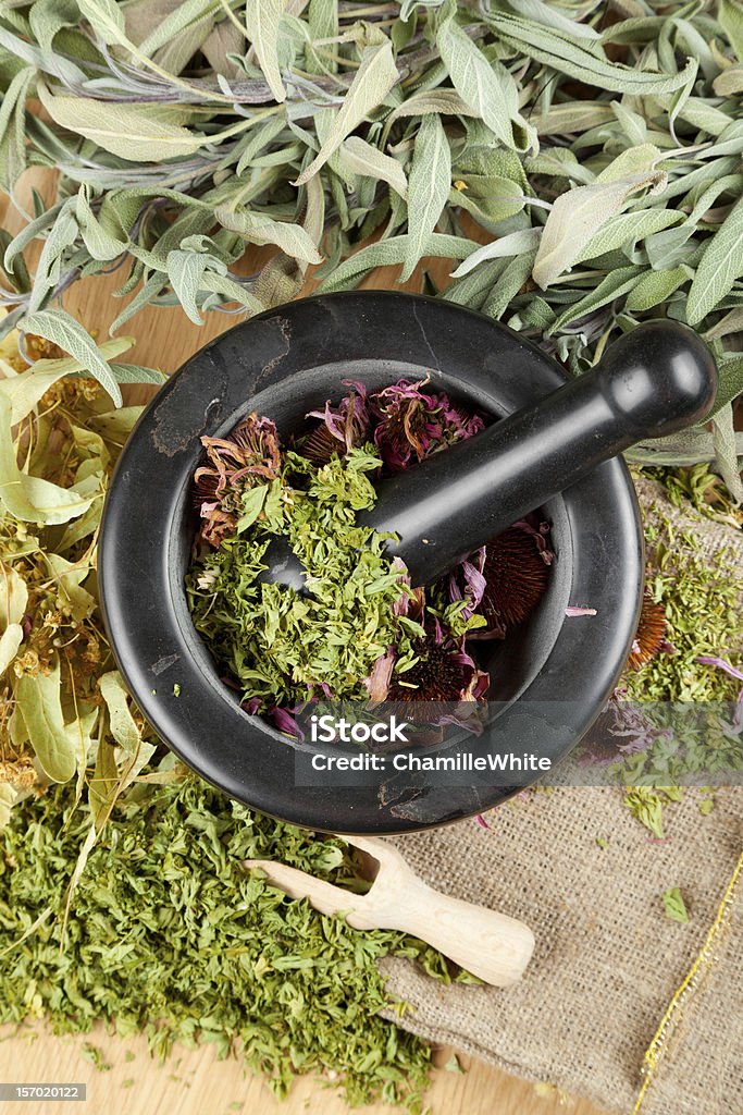 healing herbs on wooden table, mortar and pestle healing herbs on wooden table, mortar and pestle on wooden table, herbal medicine Alternative Medicine Stock Photo