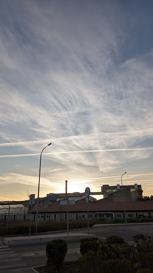 Himtrails in places where planes flew in the sky at sunset over a city in western Europe