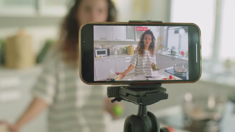 Smartphone on Tripod Filming Female Food Blogger in Kitchen