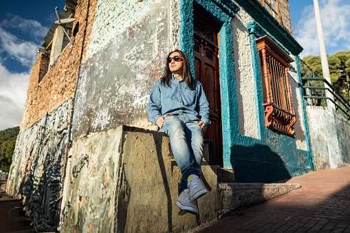 Mature man contemplating looking away at the old town