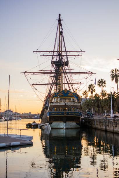 istock a large boat in the water near a dock at sunset 1570297074