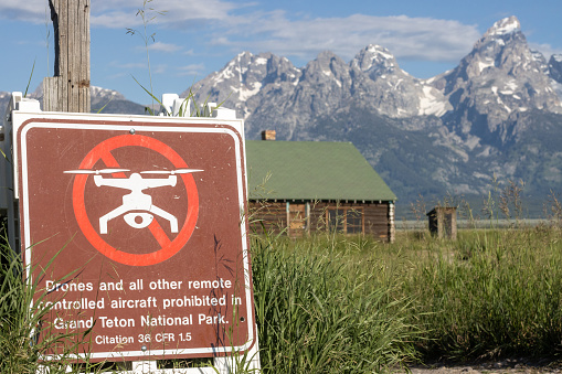 No Drones Sign on Mormon Row at Jackson Hole in Grand Teton National Park at Teton County, Wyoming, with a legal citation visible.