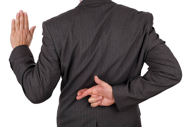 Business fraud Swearing an oath with fingers crossed behind back concept for dishonesty or business fraud greedy corporation stock pictures, royalty-free photos & images
