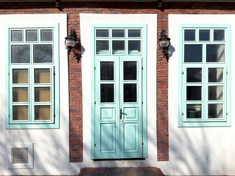 white curtains behind blue shutters