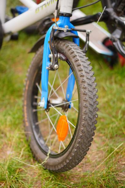 istock Wheel of a bicycle on a lush grassy field 1570360895