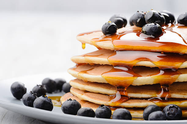 Breakfast pancakes Plate of delicious pancakes close up, with fresh blueberries and maple syrup dripping pancake stock pictures, royalty-free photos & images