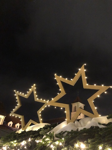 Illuminated Christmas stars with snow