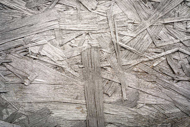 sfondo della trama del truciolato, modello del pannello osb marrone chiaro, sfondo dei trucioli di legno incollati pressati - particle plank wood brown foto e immagini stock
