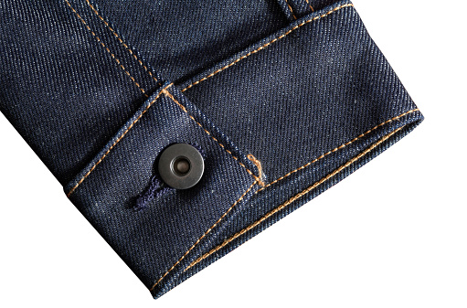 High resolution close up of denim jacket sleeve cuff shot in studio