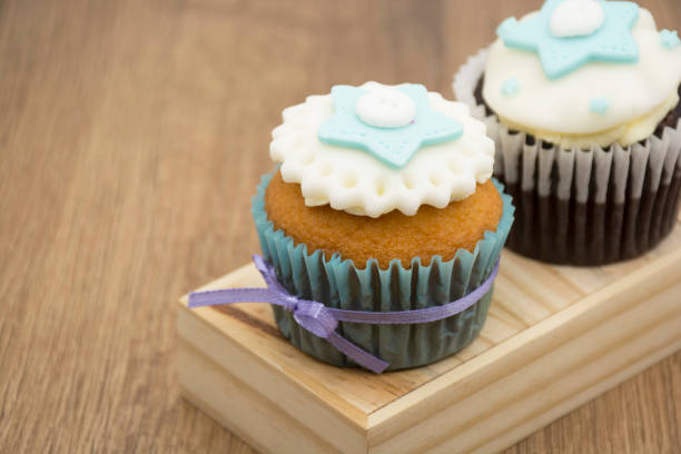 istock Cupcake decorated with white and blue cream. 1570433234