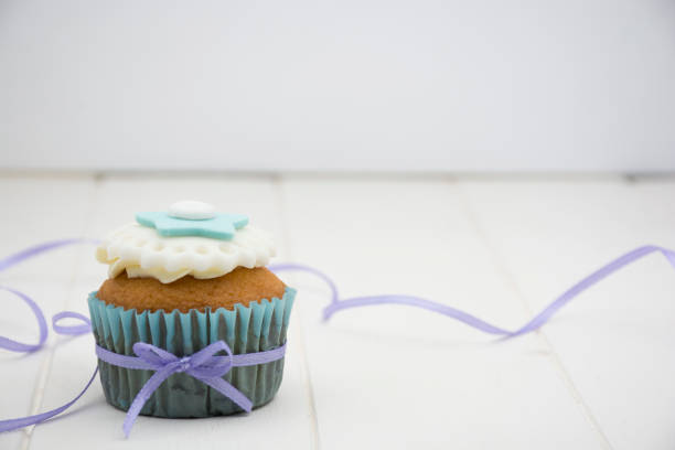 Cupcake decorated with white and blue cream.
