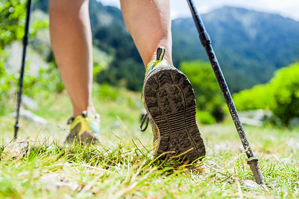 Nordic walking hiking sport shoes in mountains stock photo