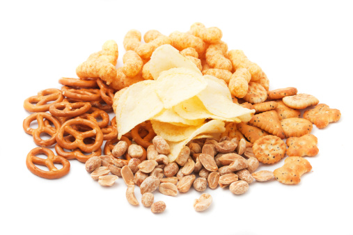 Peanuts, potato chips, pretzels ant oher salty snacks isolated on white