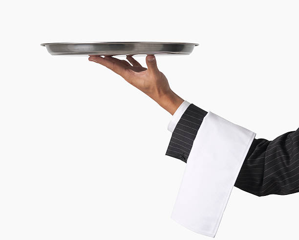 Hand of a waiter holding up an empty platter for service