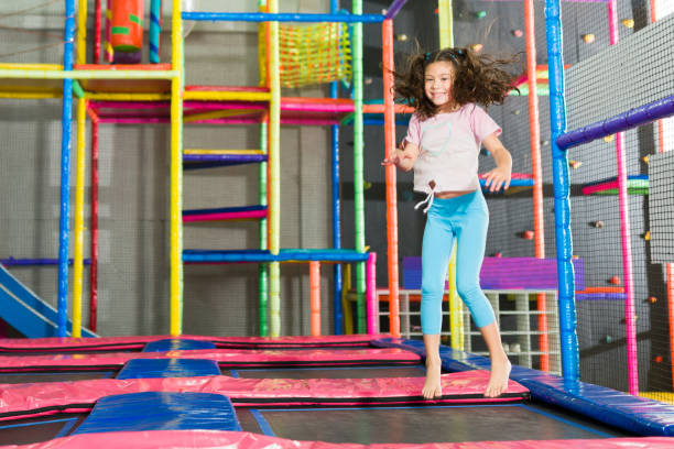 istock Happy kid having fun playing and jumping on the trampoline 1570523348